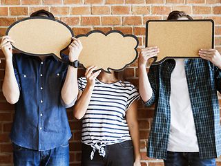 The picture shows 3 people holding empty speech and thought bubbles in front of their faces.
